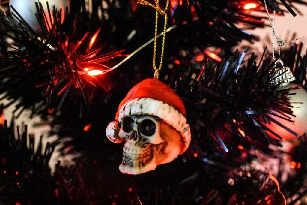Skull ornament wearing a Santa Hat on a Christmas tree